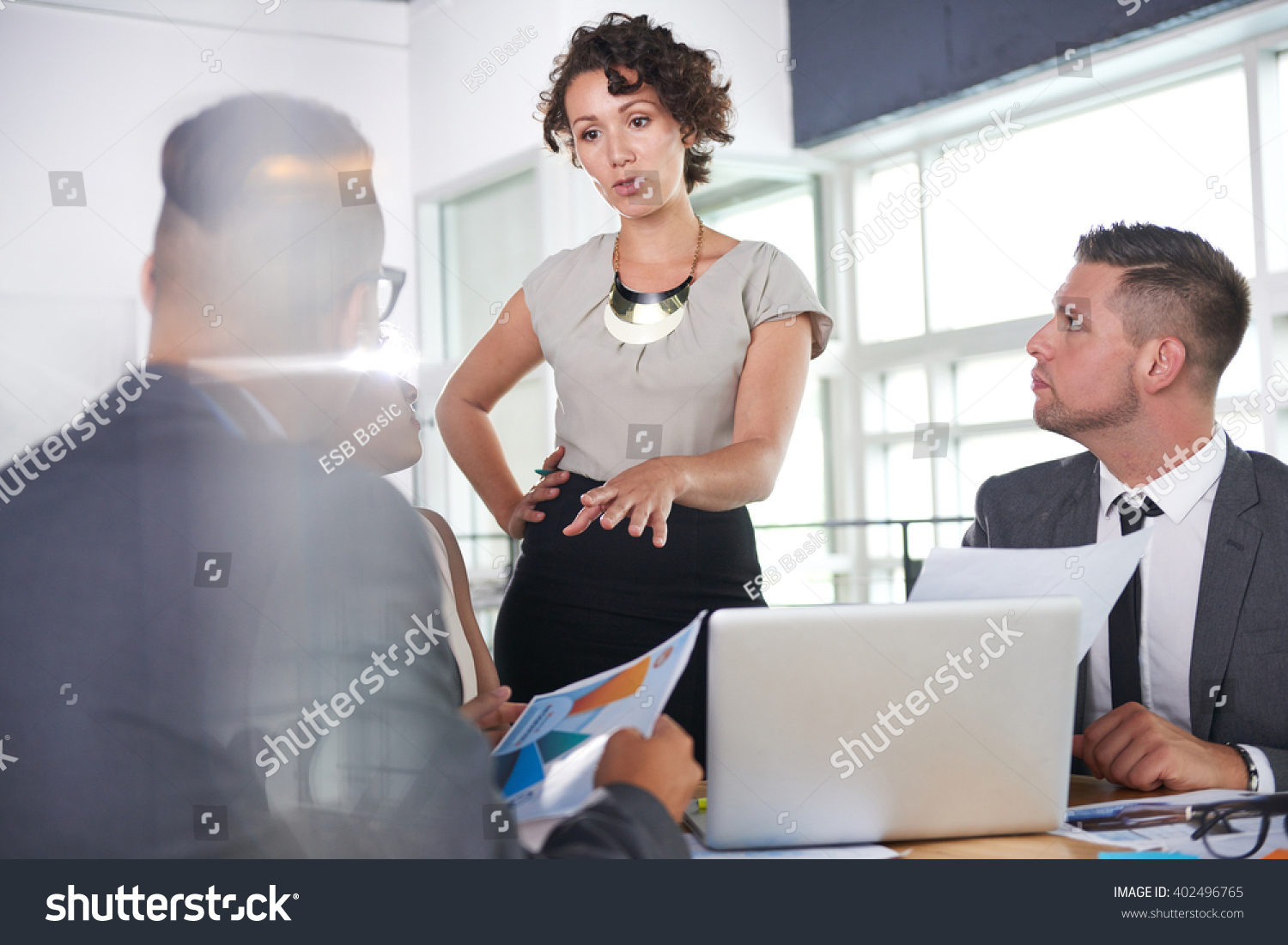 stock-photo-team-of-successful-business-people-having-a-meeting-in-executive-sunlit-office-402496765